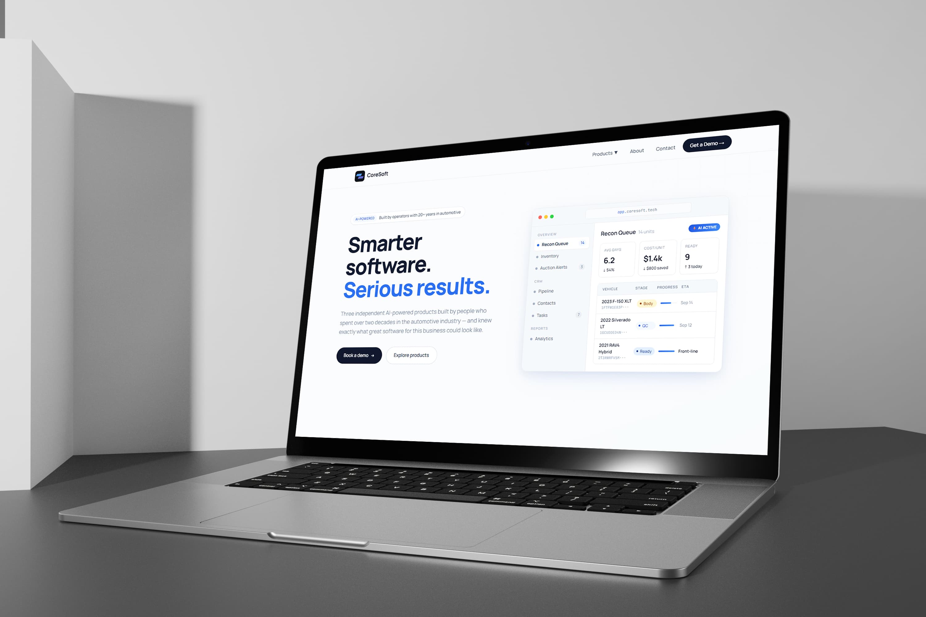 Coresoft homepage on a laptop — “Smarter software. Serious results.” with the Recon Queue dashboard